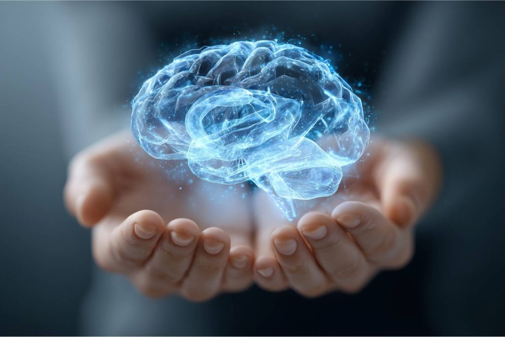 Cerebro digital sostenido por manos humanas que representa la inteligencia artificial y la innovación en el marketing digital 2026.